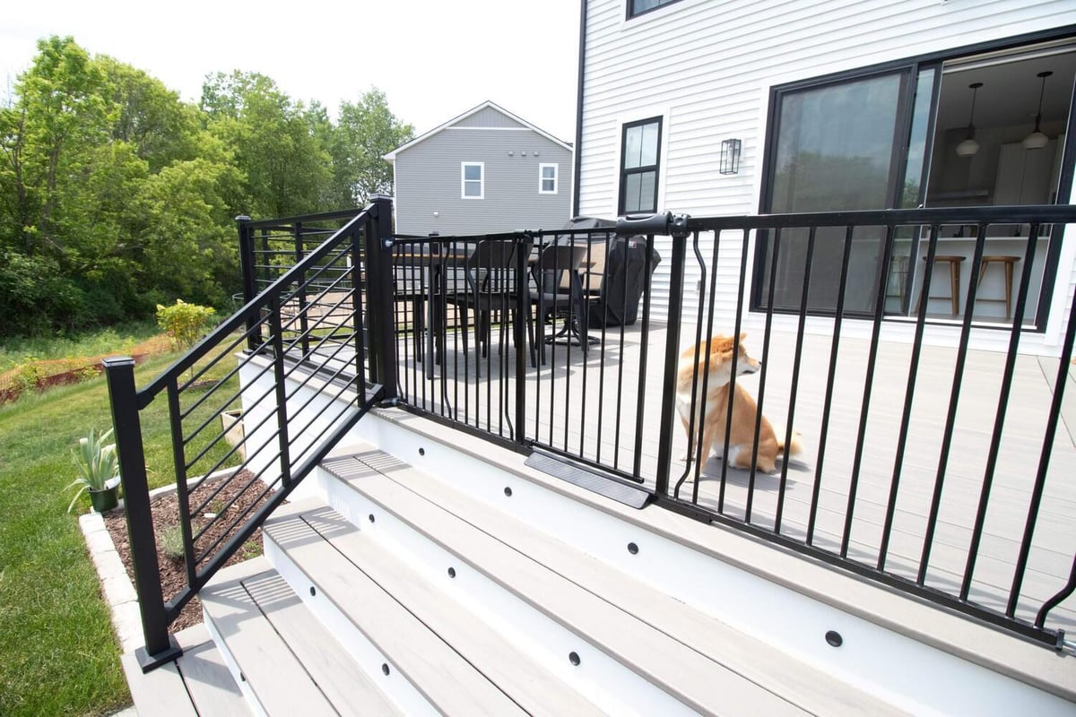 remodeled composite deck with outdoor dining area by Odd Fellows Contracting in Haslett MI