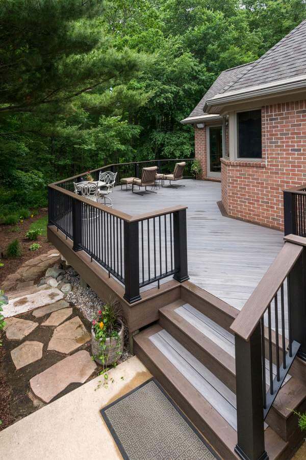 Backyard deck staircase with composite steps and railing in Williamston MI remodel by Odd Fellows Contracting