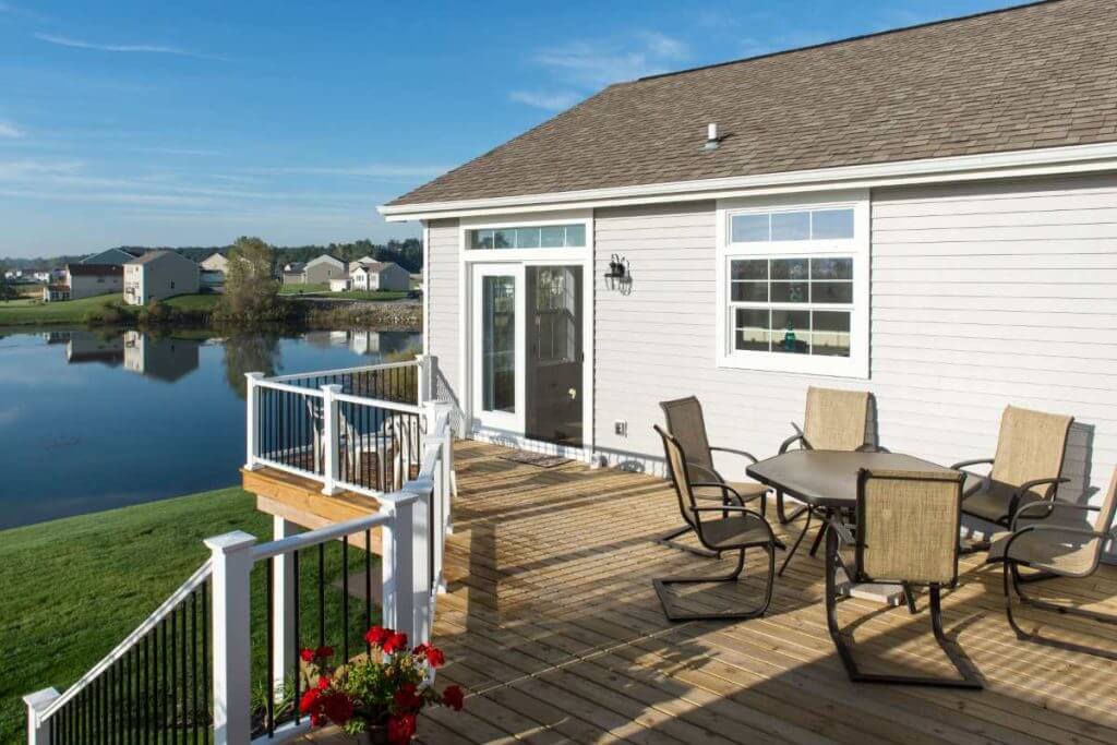 Outdoor deck dining space attached to home in Mason MI built by Odd Fellows Contracting