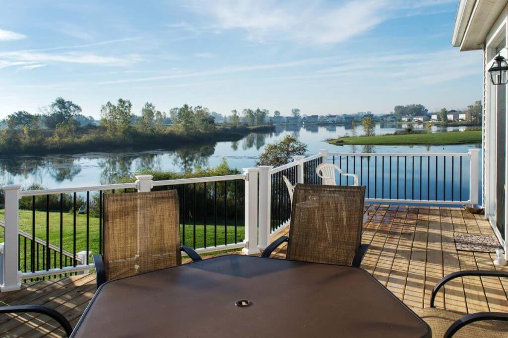 Outdoor deck seating area with lake view in Mason MI deck project by Odd Fellows Contracting