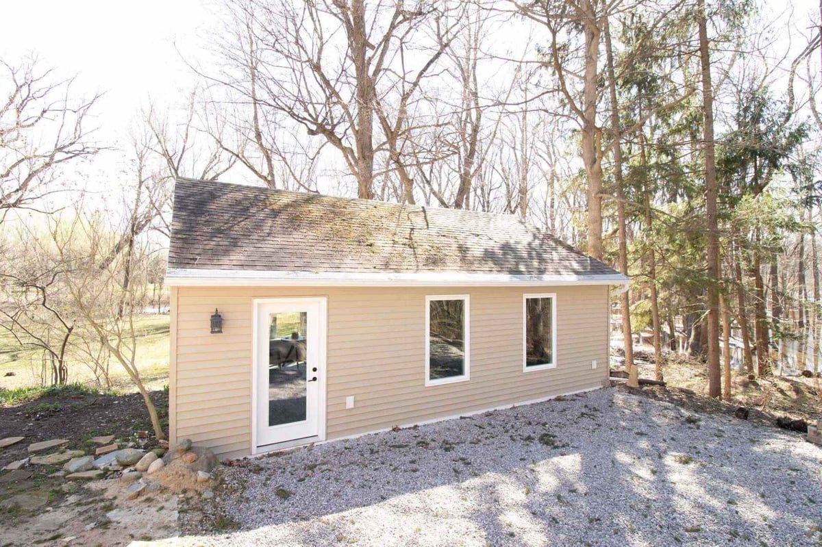 completed garage conversion exterior with new siding and windows by Odd Fellows Contracting in Okemos, MI