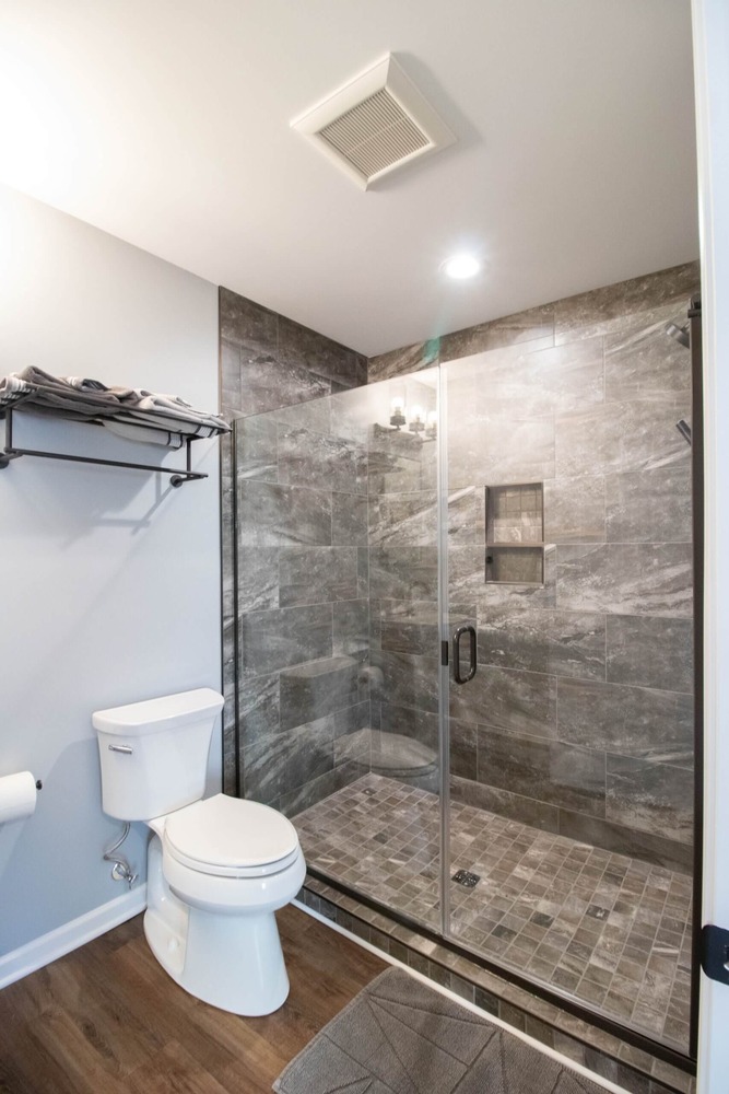 modern walk-in tile shower installed during garage conversion by Odd Fellows Contracting in Okemos, MI