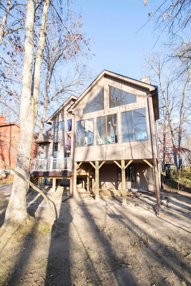 elevated four seasons room addition with large windows by Odd Fellows Contracting in Haslett MI