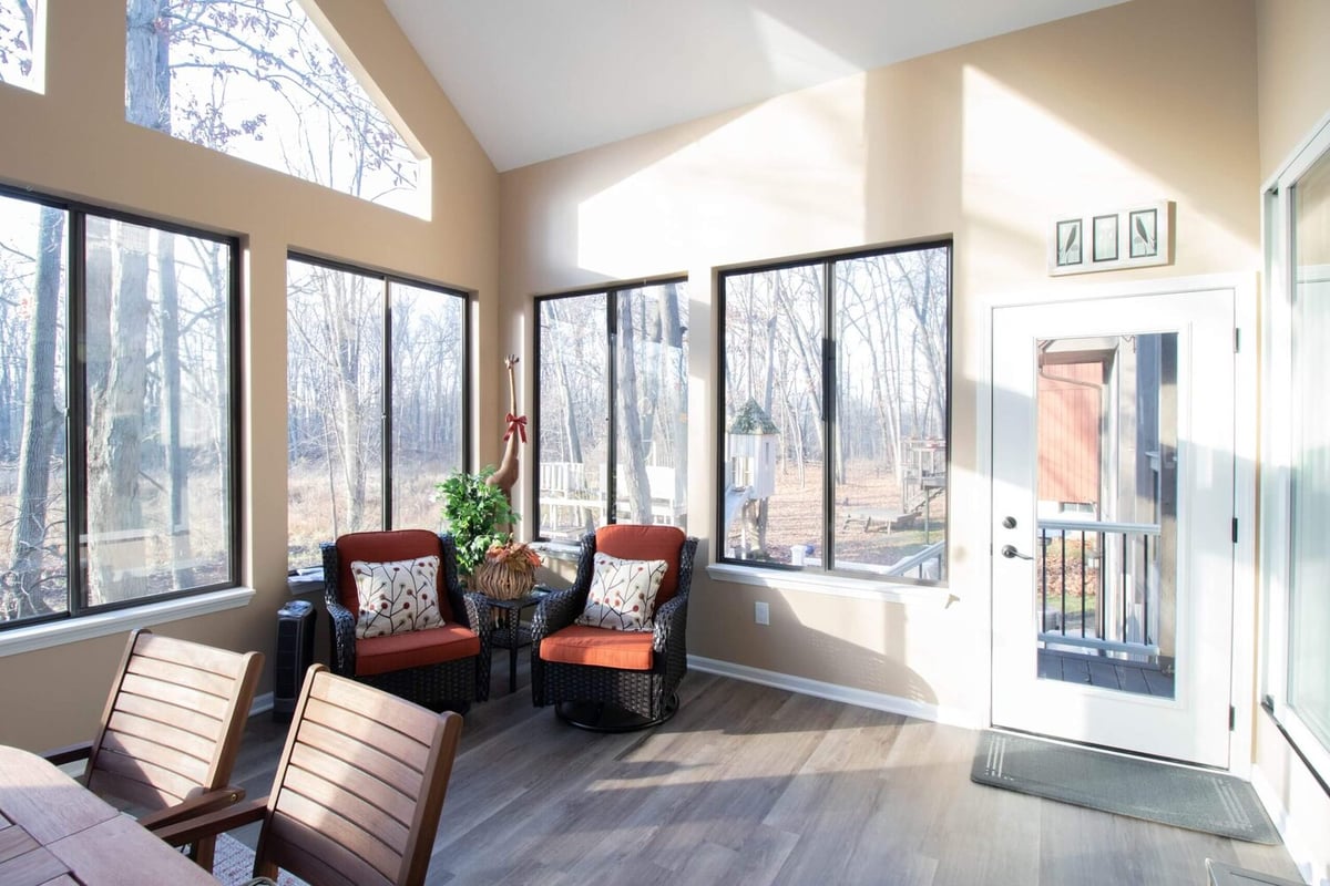 sunroom interior with lounge chairs and natural light by Odd Fellows Contracting in Haslett MI