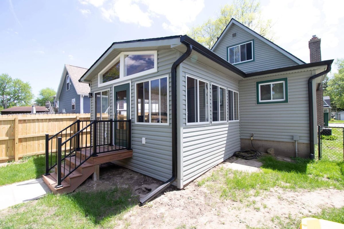 backyard view of new three seasons room addition in Holt, MI by Odd Fellows Contracting