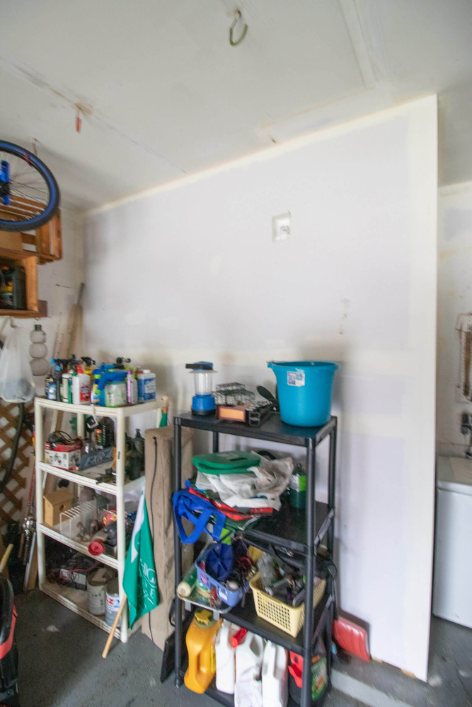 Before photo of garage area converted into laundry addition by Odd Fellows Contracting in Williamston, MI