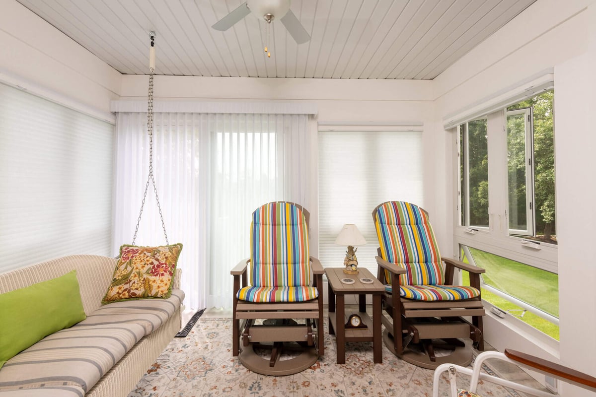 Comfortable enclosed porch living space from three seasons room project by Odd Fellows Contracting in Holt, MI