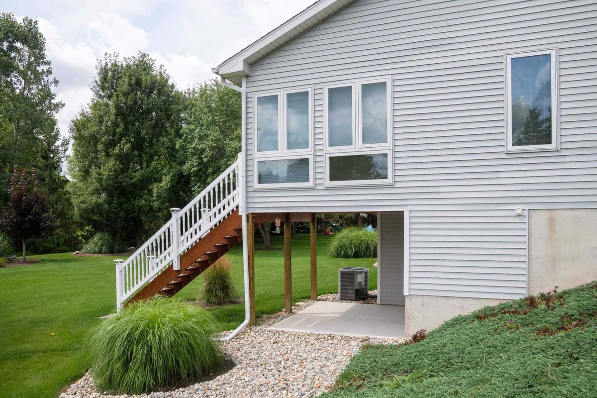 Side exterior of enclosed sunroom addition by Odd Fellows Contracting in Holt, MI