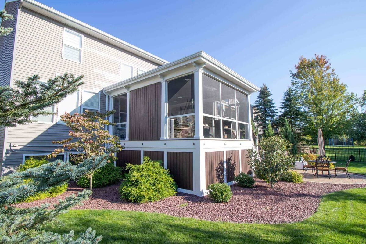 backyard view of screened three season room addition by Odd Fellows Contracting in Okemos MI