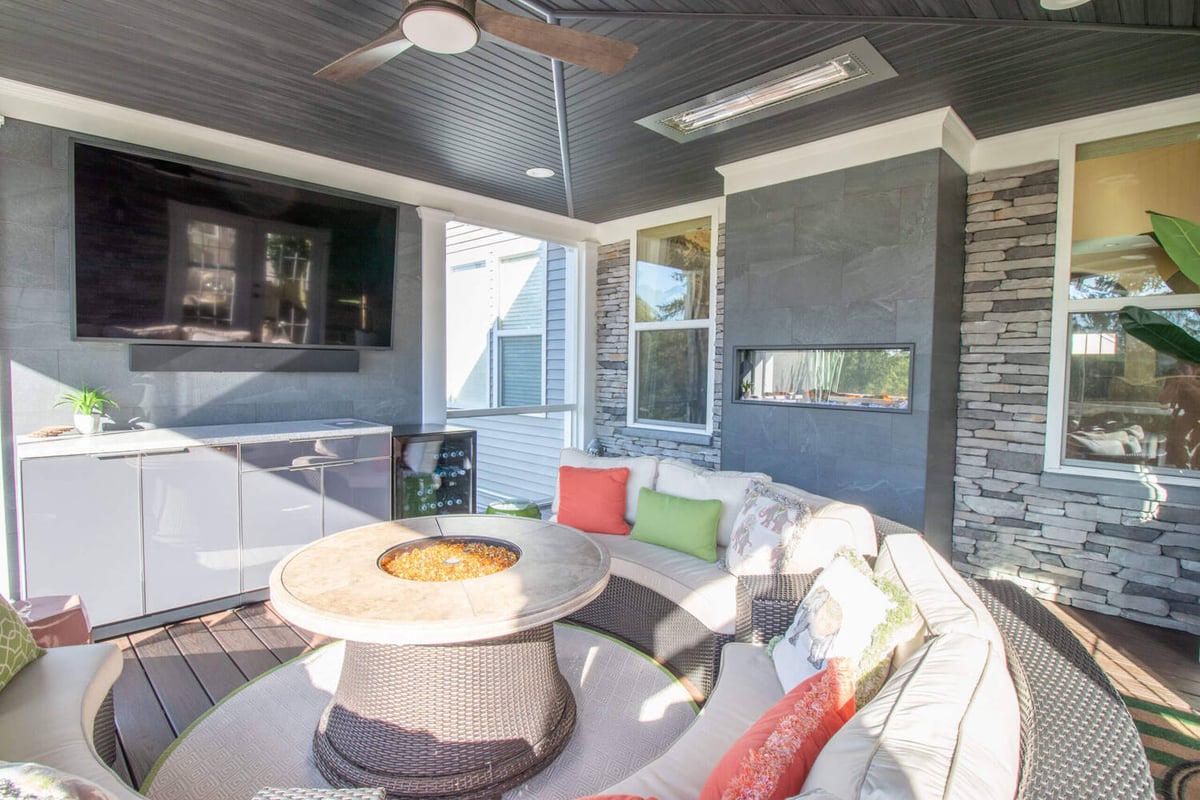 custom three season room lounge area with ceiling fan by Odd Fellows Contracting Okemos MI