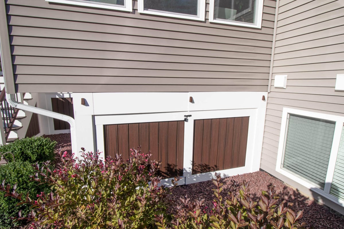exterior under deck storage doors for three season room addition by Odd Fellows Contracting Okemos MI
