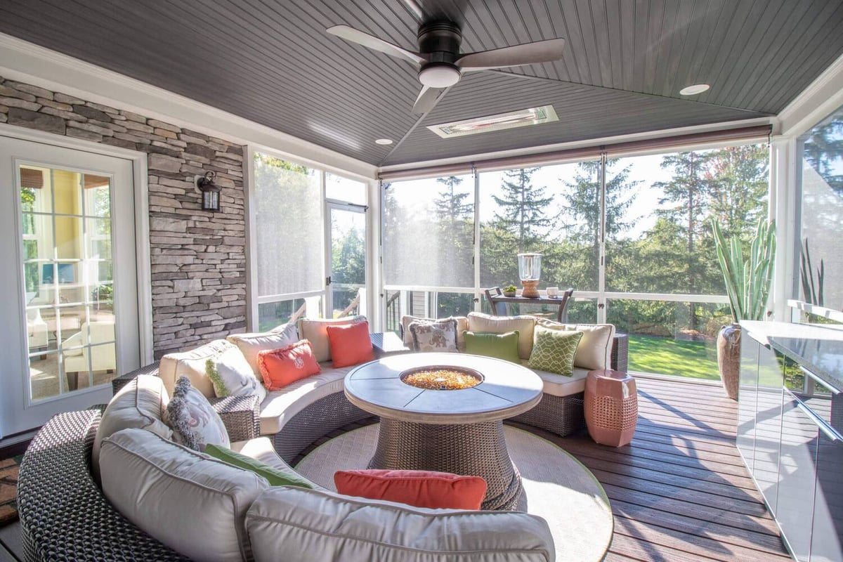interior three season room addition with seating and fire table by Odd Fellows Contracting in Okemos MI