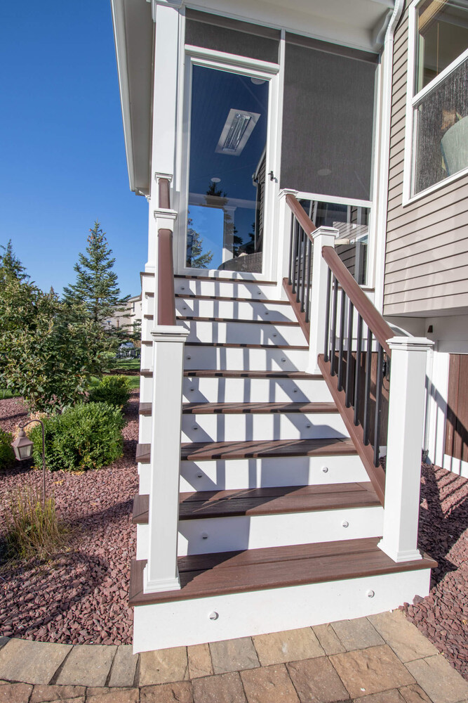 staircase leading to elevated three season room addition entrance by Odd Fellows Contracting Okemos MI