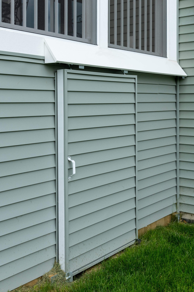 built in storage area under deck with siding door by Odd Fellows Contracting Lansing MI