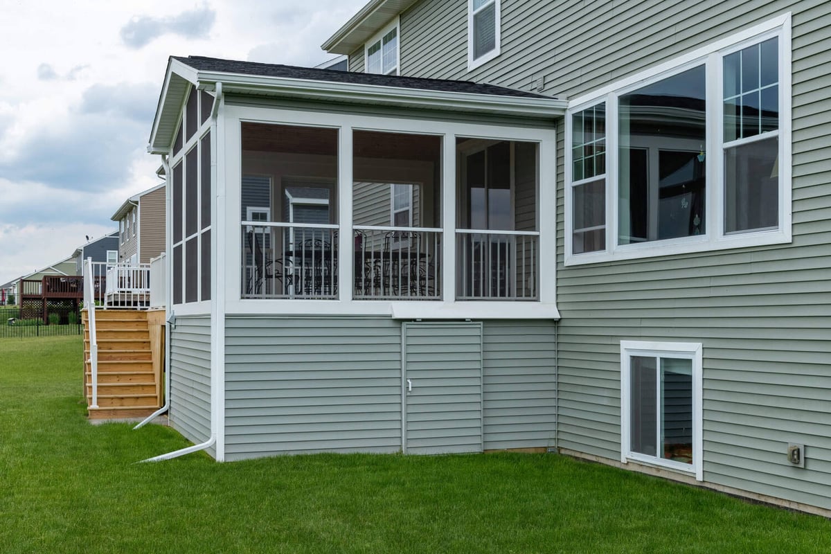 exterior view of custom three season room addition with deck by Odd Fellows Contracting in Lansing MI