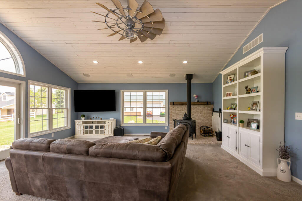 custom living space with fireplace stove and built in cabinets by Odd Fellows Contracting Williamston MI