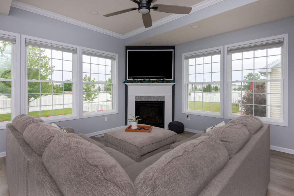 bright living room addition with large windows and fireplace by Odd Fellows Contracting in East Lansing MI
