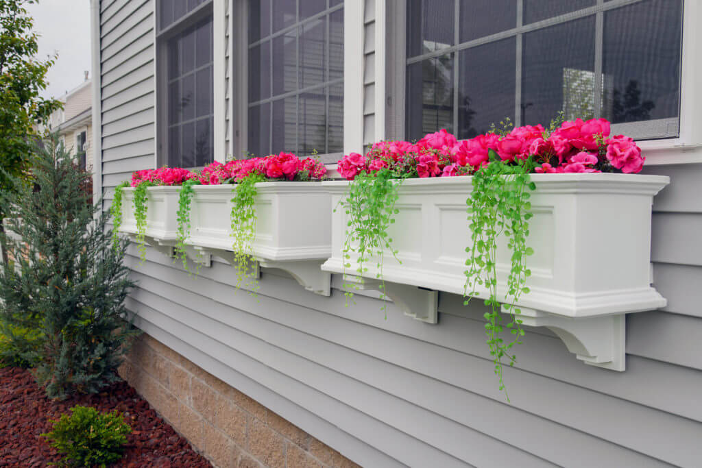 close up of custom window boxes with flowers on home addition by Odd Fellows Contracting East Lansing MI