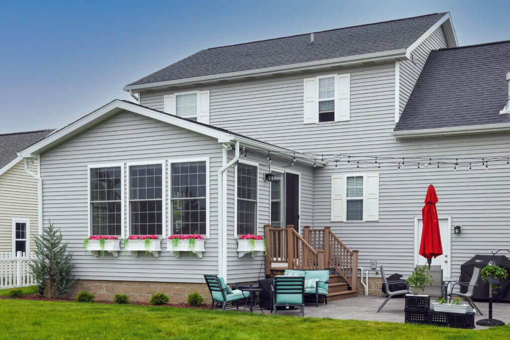 exterior home addition with large windows and backyard patio by Odd Fellows Contracting in East Lansing MI