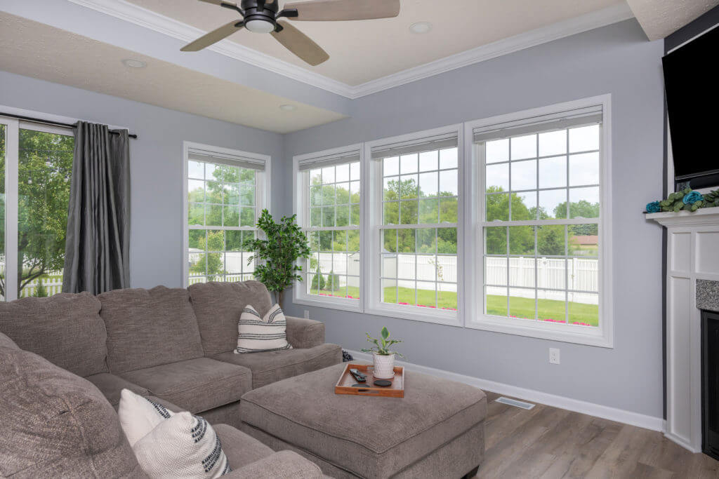 living room addition with large windows and sectional seating by Odd Fellows Contracting in East Lansing MI