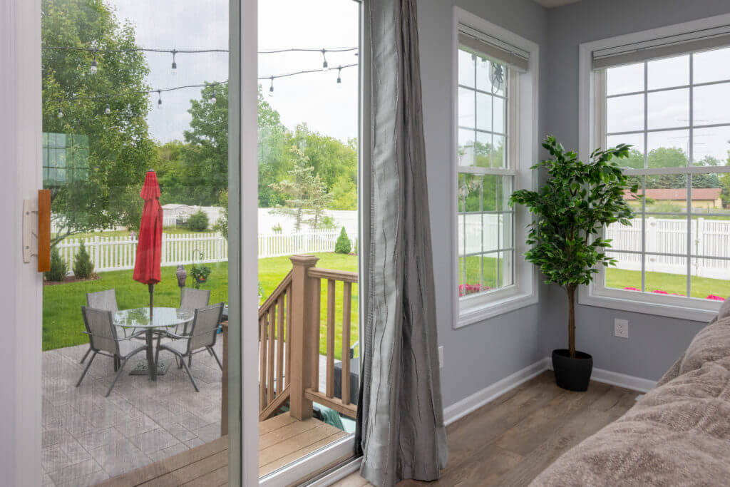 sliding door view from living room addition to backyard patio by Odd Fellows Contracting in East Lansing MI