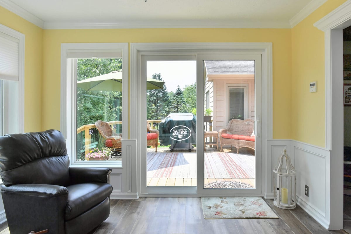 bright sunroom interior with wide windows overlooking yard by Odd Fellows Contracting in Okemos, MI