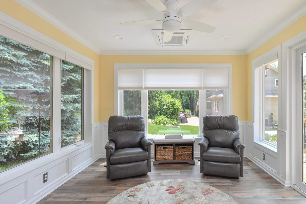 bright sunroom remodel with large windows overlooking backyard by Odd Fellows Contracting in Okemos, MI