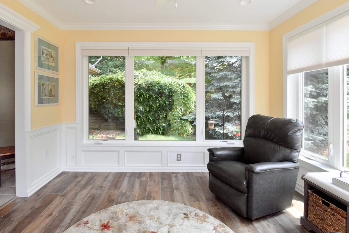 finished sunroom with wood flooring and natural light by Odd Fellows Contracting in Okemos, MI