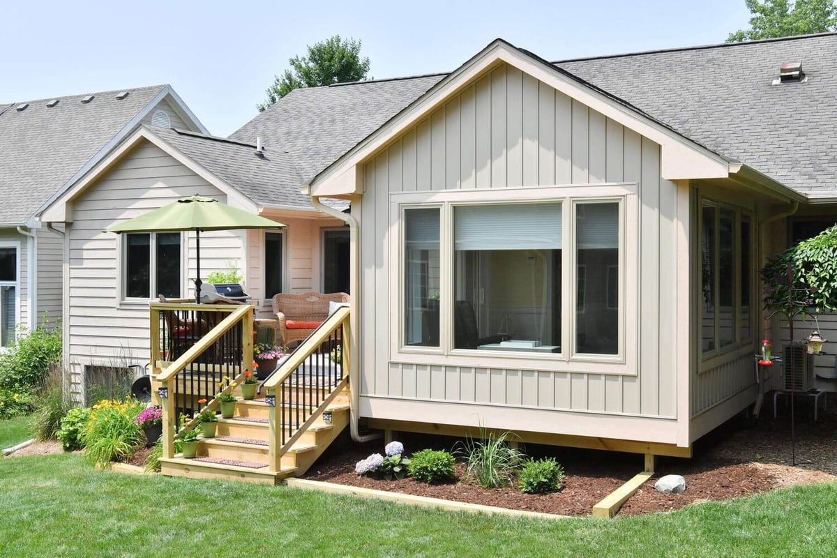 sunroom and raised deck addition connected to home by Odd Fellows Contracting in Okemos, MI
