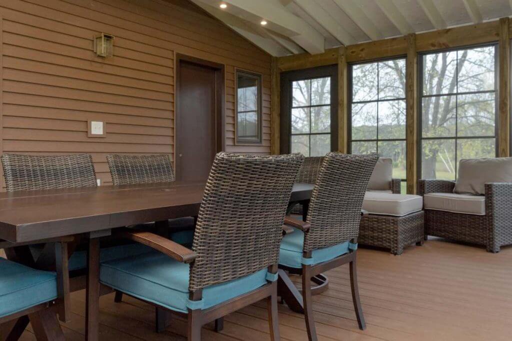 interior view of screened three seasons room with outdoor dining table by Odd Fellows Contracting in Grand Ledge MI