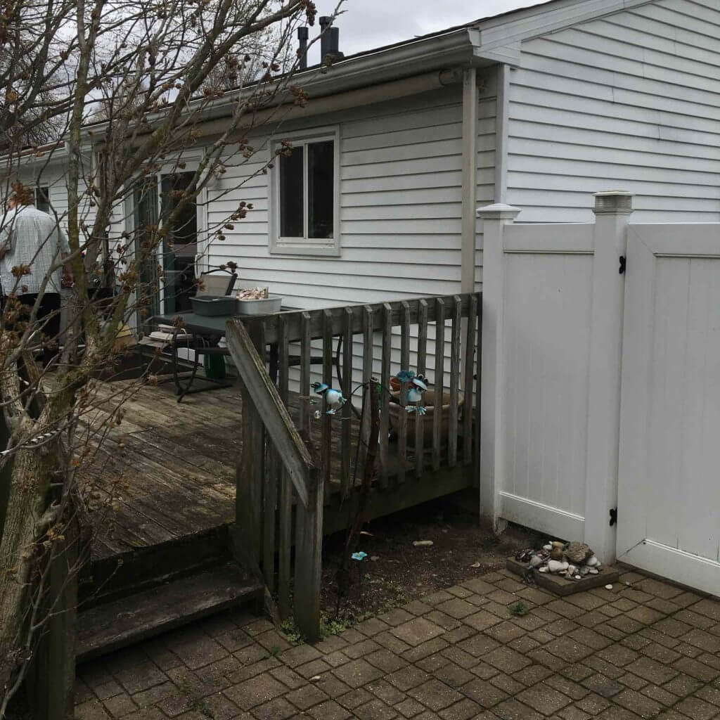 Backyard deck area before home addition construction by Odd Fellows Contracting in Lansing Michigan