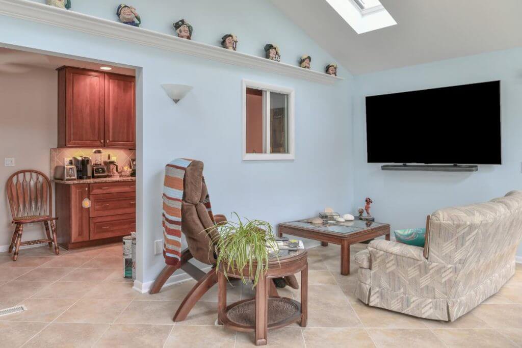 Bright sunroom addition with seating area built by Odd Fellows Contracting in Lansing MI