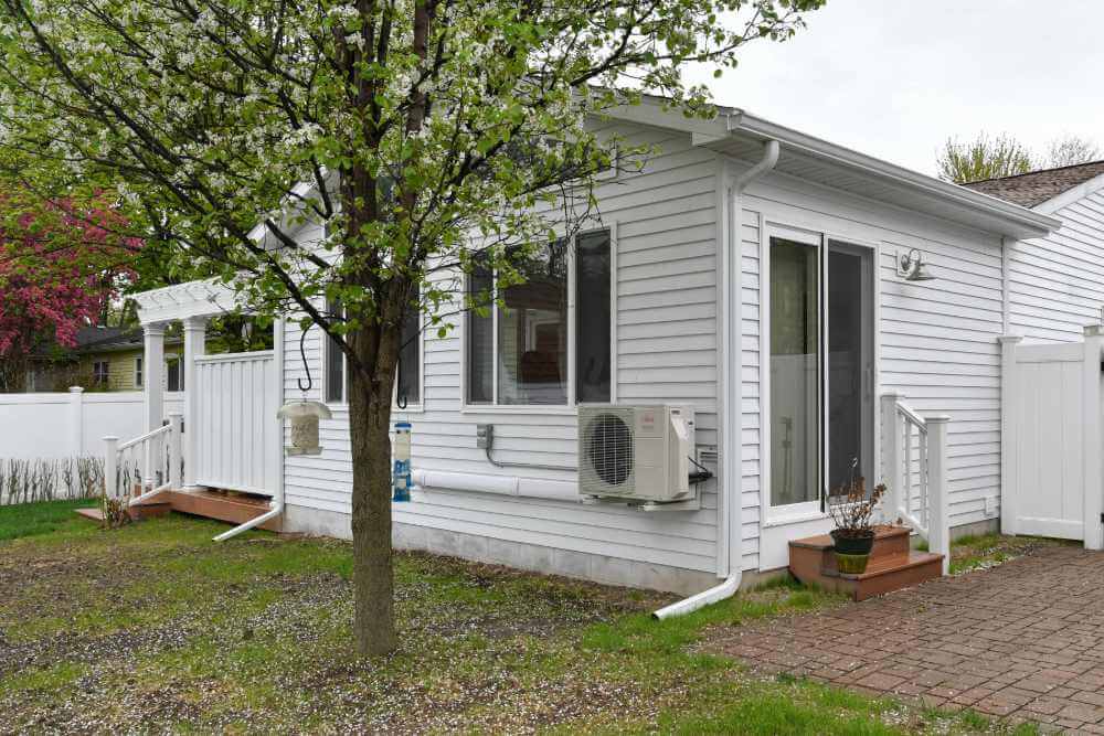 Exterior view of finished home addition with new siding and windows in Lansing Michigan
