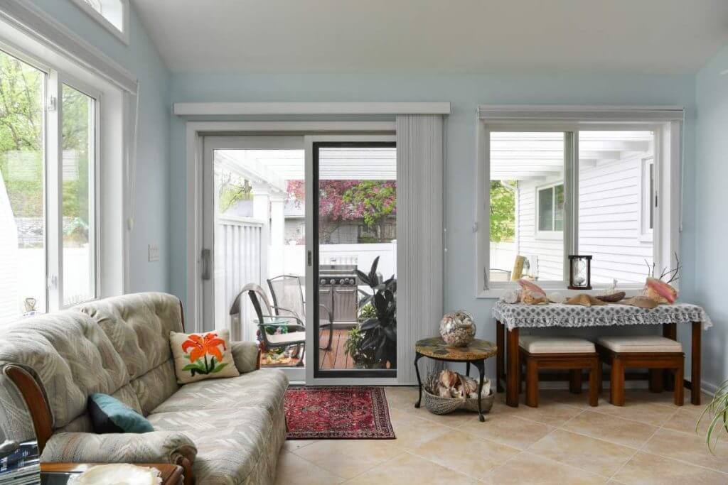 Interior view of new sunroom addition with large windows in Lansing Michigan home renovation