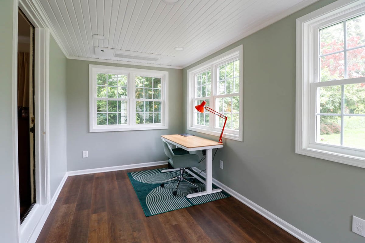 Orchard-Street, MI sunroom addition by Odd Fellows Contracting featuring home office setup and hardwood floors.