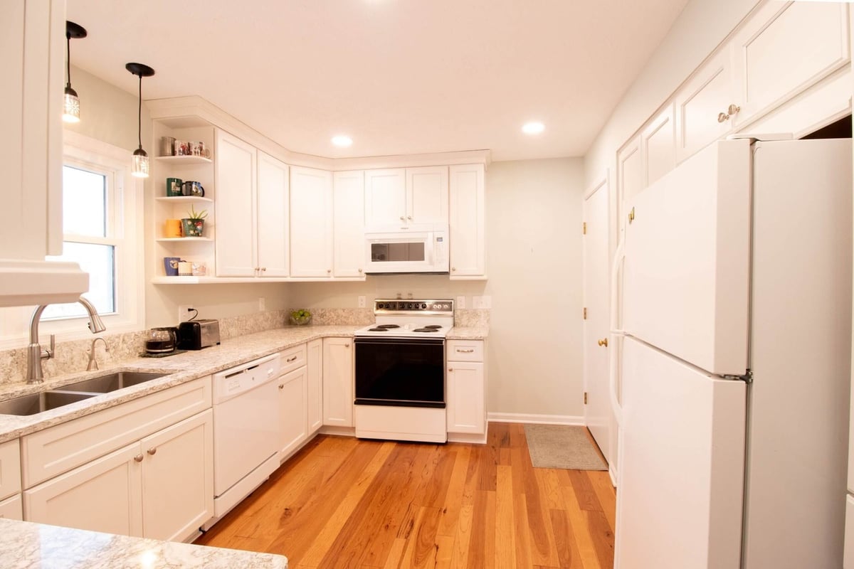 bright kitchen remodel with new cabinetry and pendant lighting by Odd Fellows Contracting in Onondaga, MI