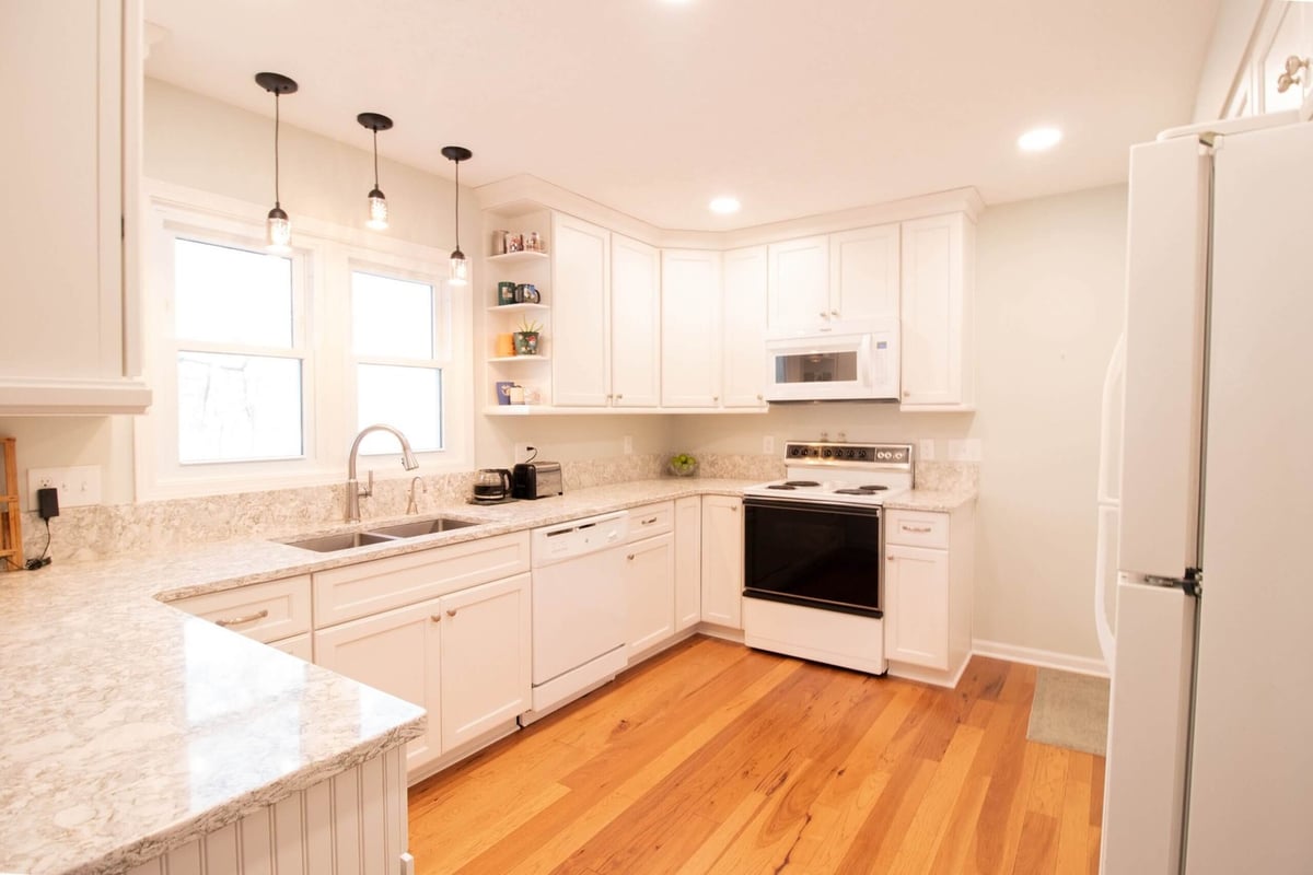 remodeled kitchen with white shaker cabinets and granite countertops by Odd Fellows Contracting in Onondaga, MI