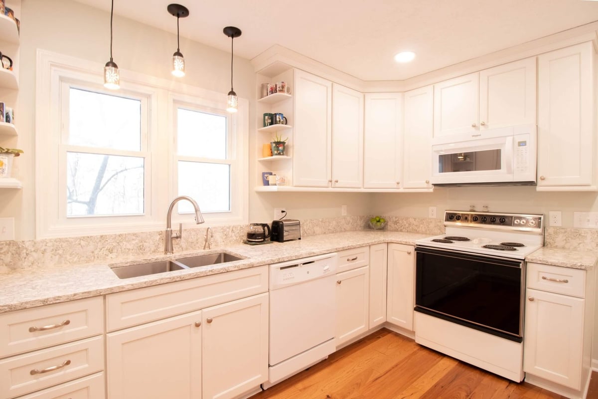 renovated kitchen with stainless sink and pendant lighting by Odd Fellows Contracting in Onondaga, MI