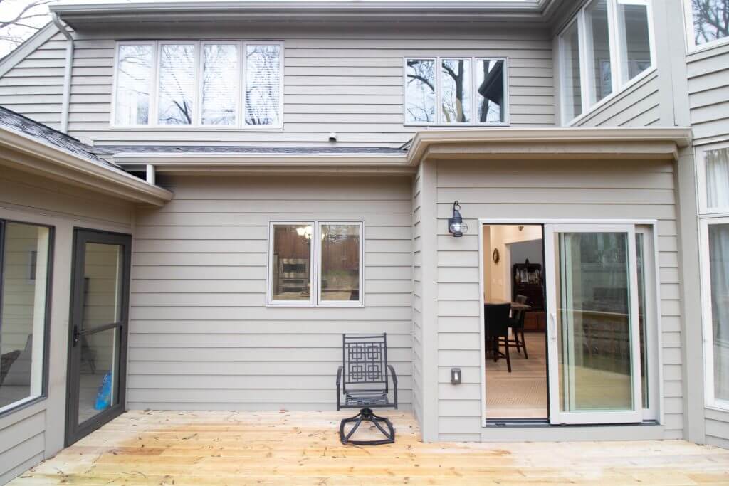 exterior view of home with new deck addition from kitchen remodel by Odd Fellows Contracting in Okemos, MI