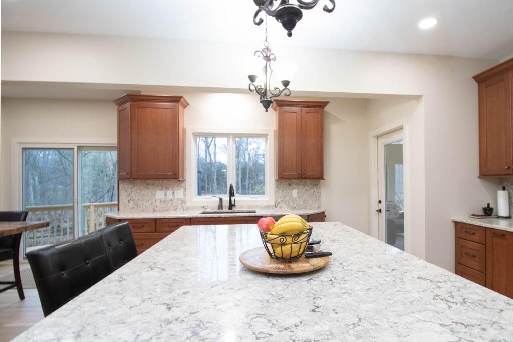kitchen remodel detail showing large island and seating area by Odd Fellows Contracting in Okemos, MI