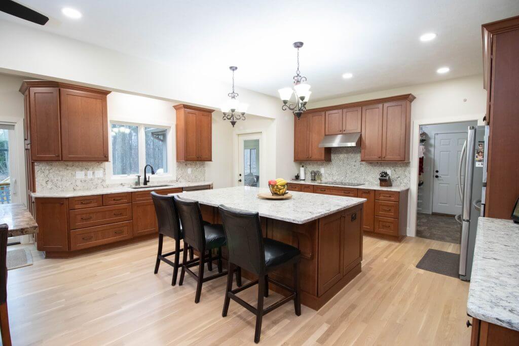 kitchen remodel featuring spacious island and wood cabinetry by Odd Fellows Contracting in Okemos, MI