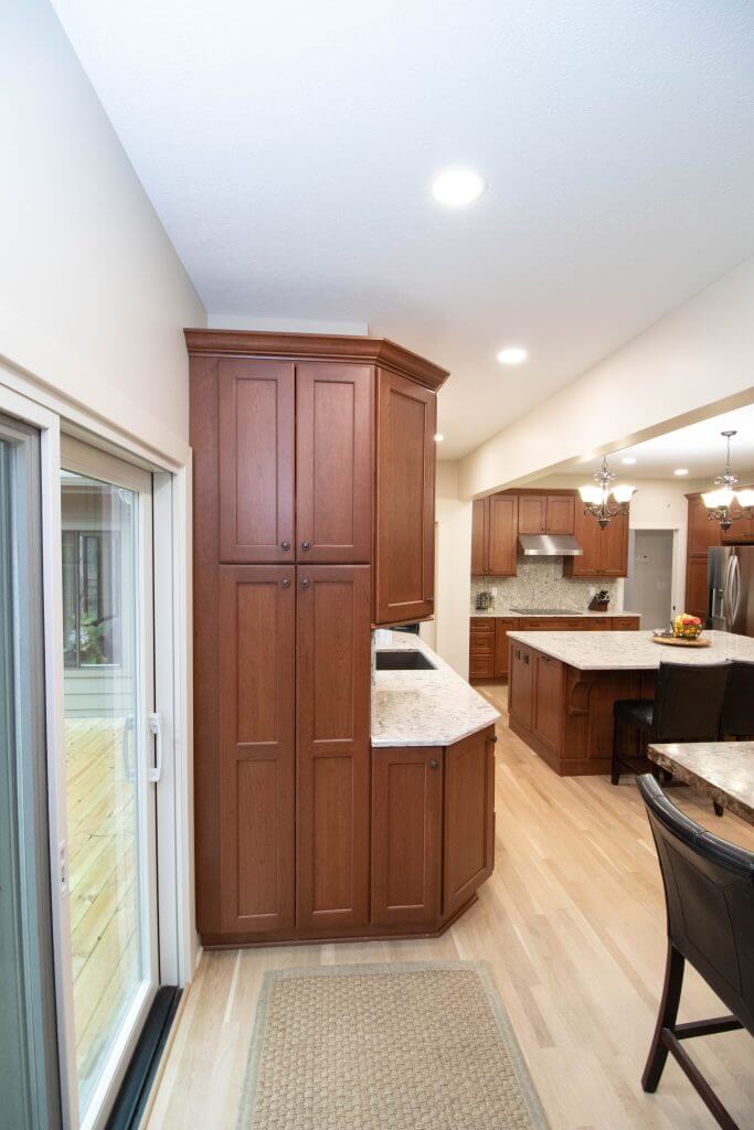 kitchen remodel with tall pantry cabinets and quartz counters by Odd Fellows Contracting in Okemos, MI