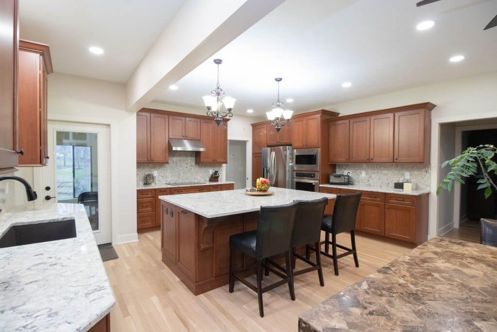 remodeled kitchen featuring custom wood cabinets and quartz countertops by Odd Fellows Contracting in Okemos, MI
