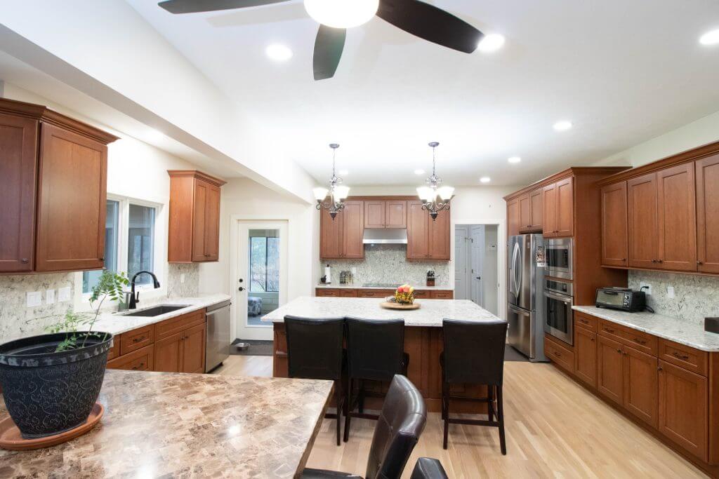 updated kitchen layout with hardwood flooring and modern cabinetry by Odd Fellows Contracting in Okemos, MI