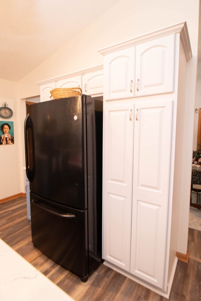 updated kitchen cabinetry with built-in refrigerator space by Odd Fellows Contracting in Charlotte, MI