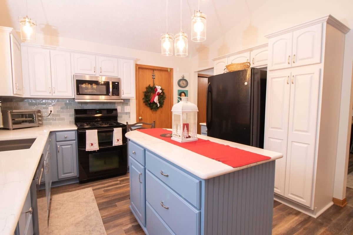updated kitchen with pendant lighting and center island by Odd Fellows Contracting in Charlotte, MI