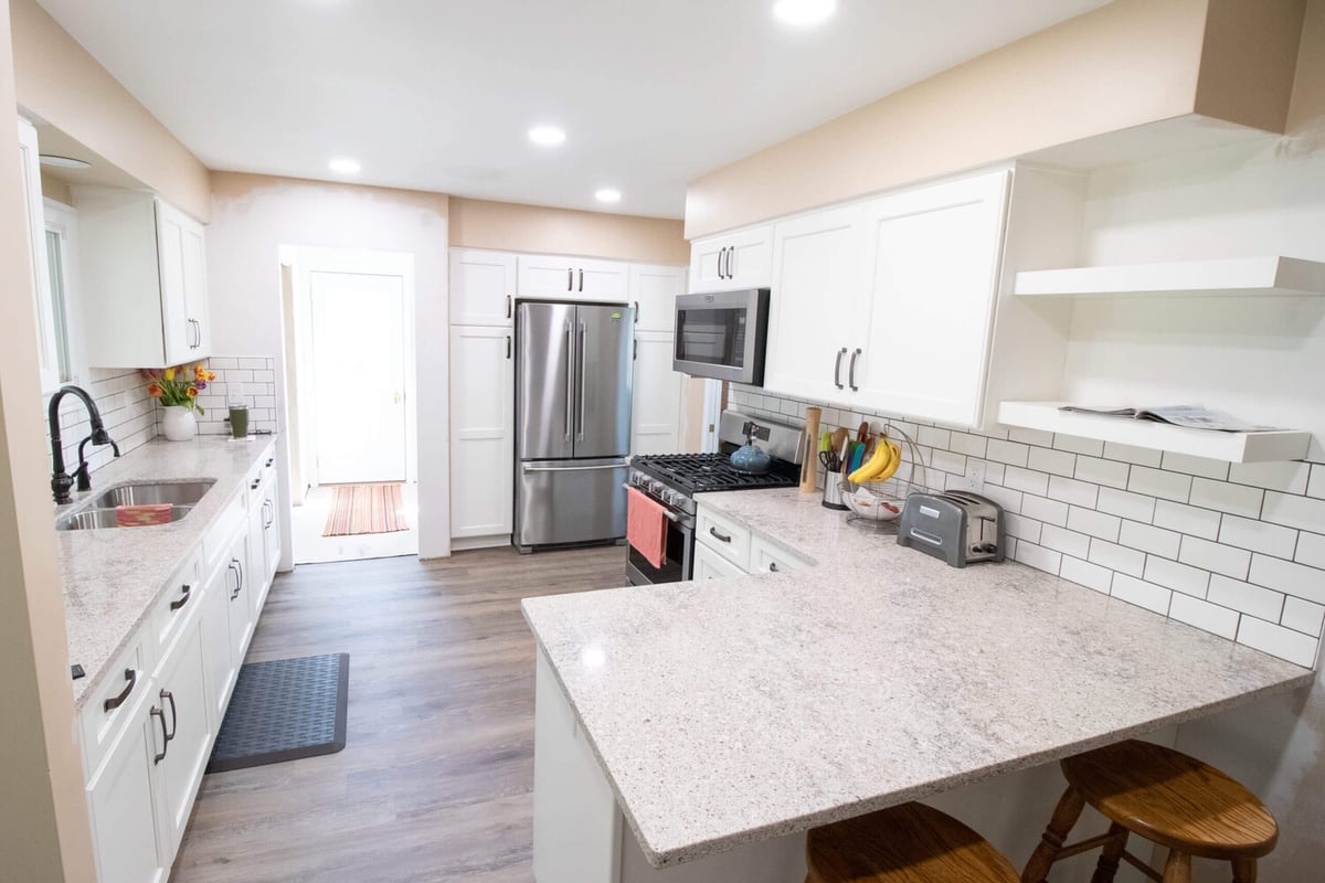 Galley kitchen remodel with quartz countertops and stainless appliances by Odd Fellows Contracting in Eaton Rapids, MI