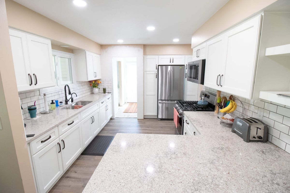 Modern kitchen remodel with peninsula counter and stainless appliances by Odd Fellows Contracting in Eaton Rapids, MI