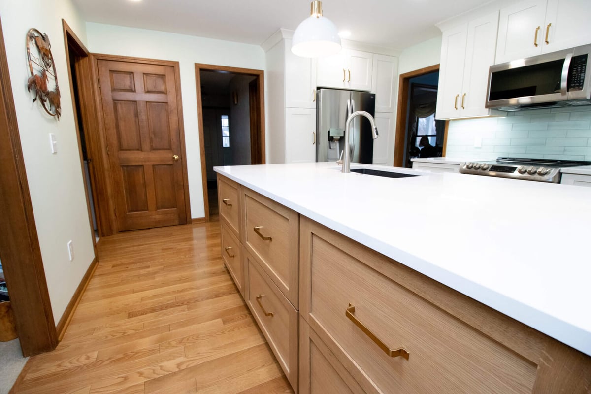 kitchen remodel featuring stainless steel range, microwave, and white subway tile backsplash by Odd Fellows Contracting in Okemos, MI