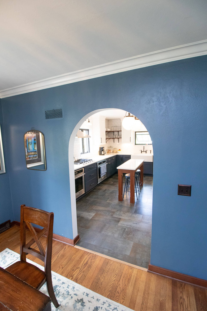 dining room view through archway into remodeled kitchen by Odd Fellows Contracting in East Lansing MI